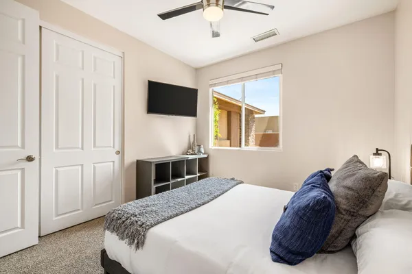 a bedroom with a bed and a flat tv screen