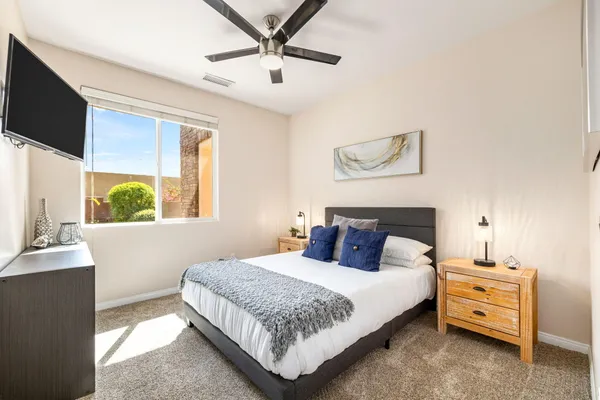 a bedroom with a balcony a bed and a flat screen tv