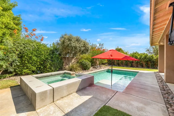 an outdoor space with pool and furniture