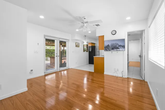 a view of a kitchen with furniture and wooden floor