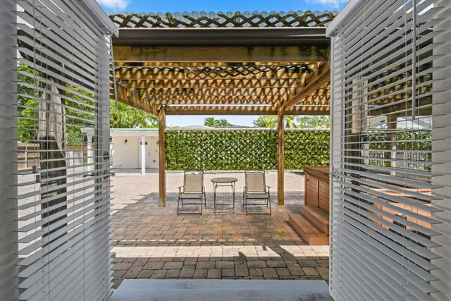 a view of a porch with a table and chairs