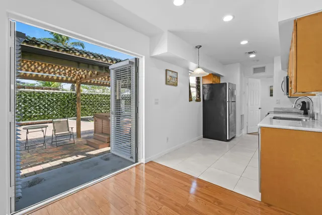 a open kitchen with a sink and refrigerator