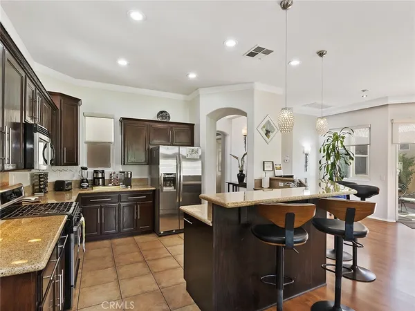 a kitchen with lots of counter top space appliances and furniture