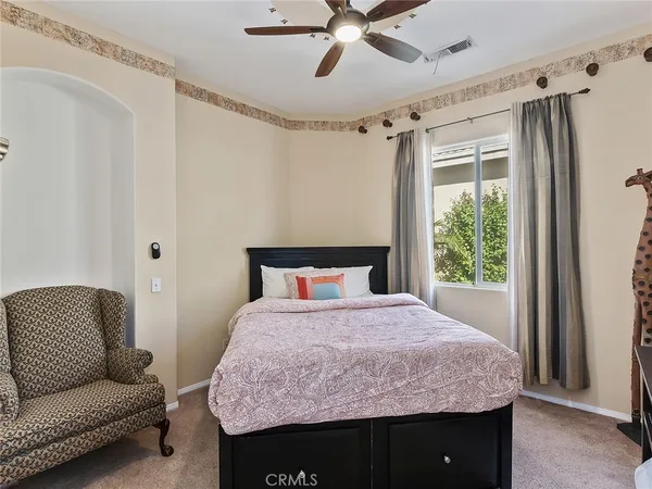 a bedroom with a bed and a couch