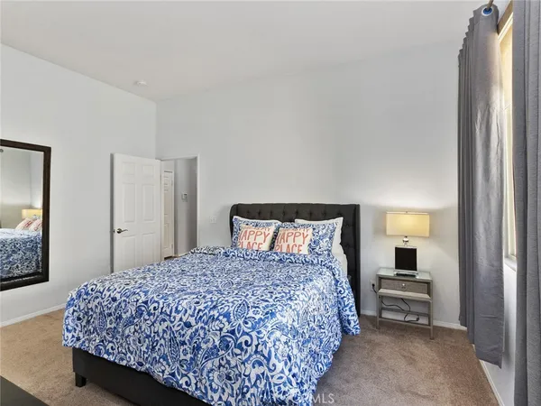 a bedroom with a bed and a mirror