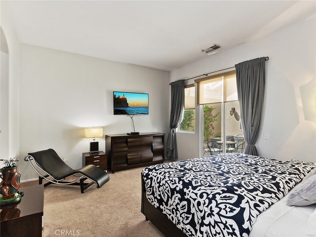 48957 Heifitz Drive Indio, CA 92201 - Photo 19 of 34 a bedroom with a bed and a window
