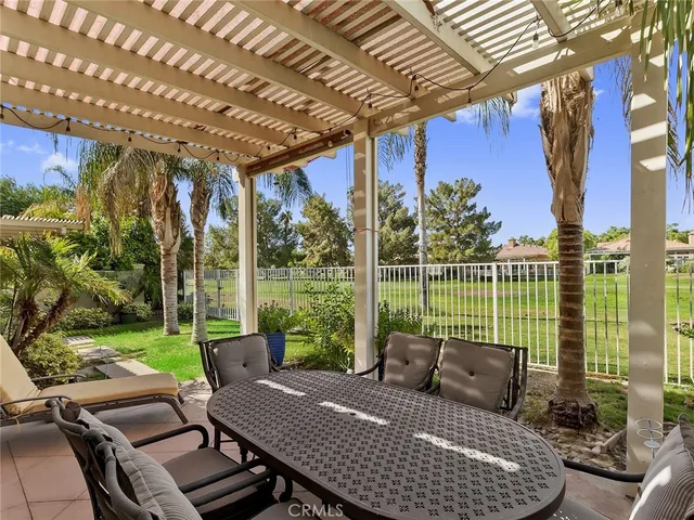 a view of a patio with couches chairs and wooden floor