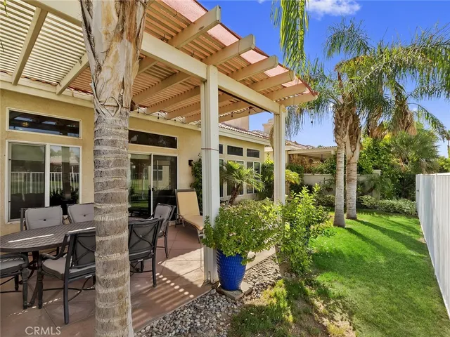 a view of a patio with table and chairs and potted plants