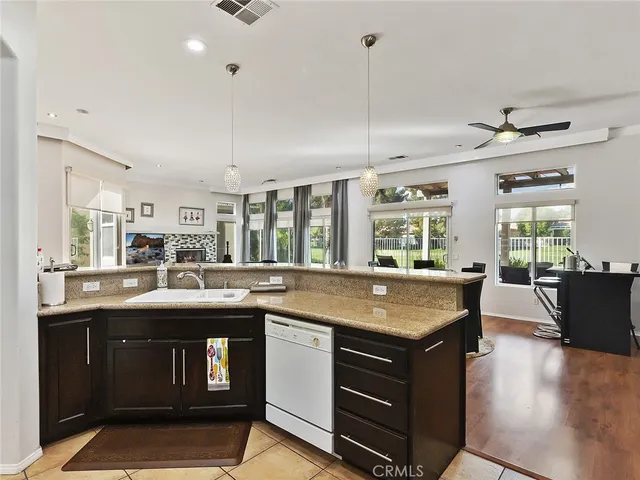 a kitchen with kitchen island granite countertop a stove and a sink