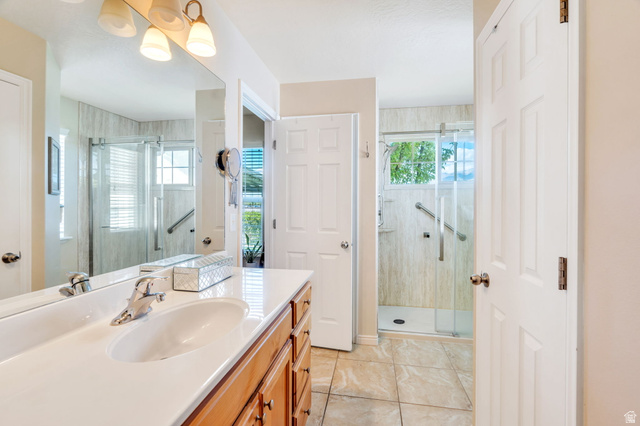 1602 Renaissance Way Springville, UT 84663 - Photo 17 of 42 Bathroom featuring vanity, a shower stall, and light tile patterned flooring