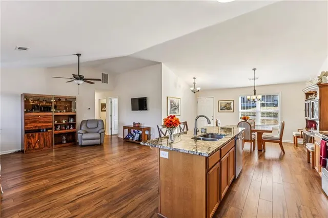 a very nice looking living room with wooden floor and furniture