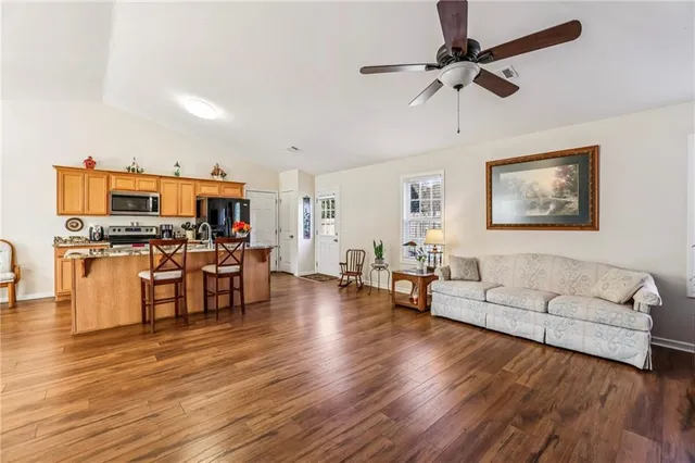 a living room with furniture and kitchen view