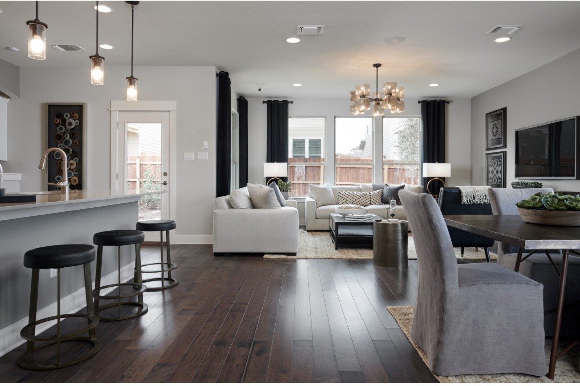 112 Leon Loop Liberty Hill, TX 78642 - Photo 2 of 12 Sleek wood-like porcelain tile flow throughout main living areas. Representative photo, actual floor color is gray