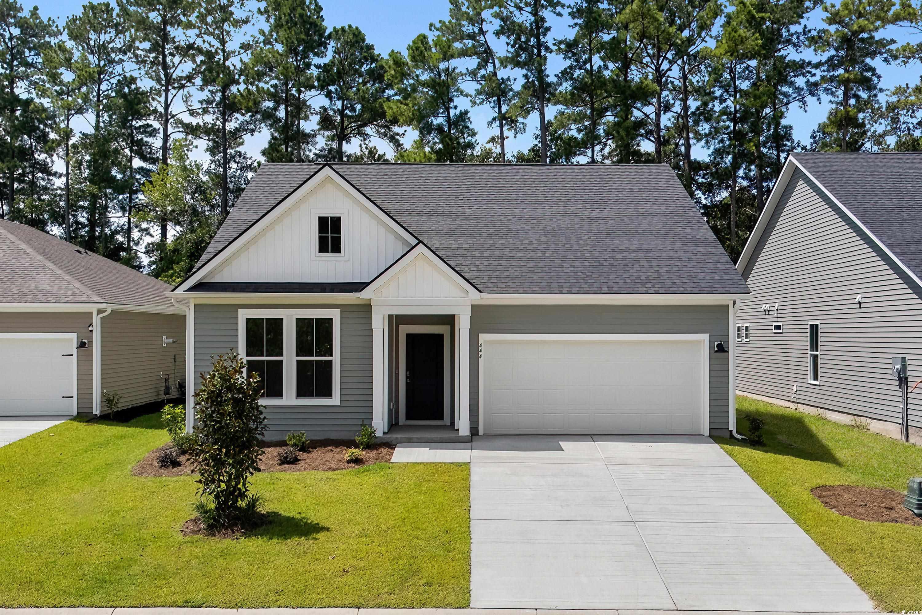 444 Sun Colony Boulevard Longs, SC 29568 - Photo 1 of 31 Front of home featuring a 4 car driveway, 2 car garage, and board and batten siding.