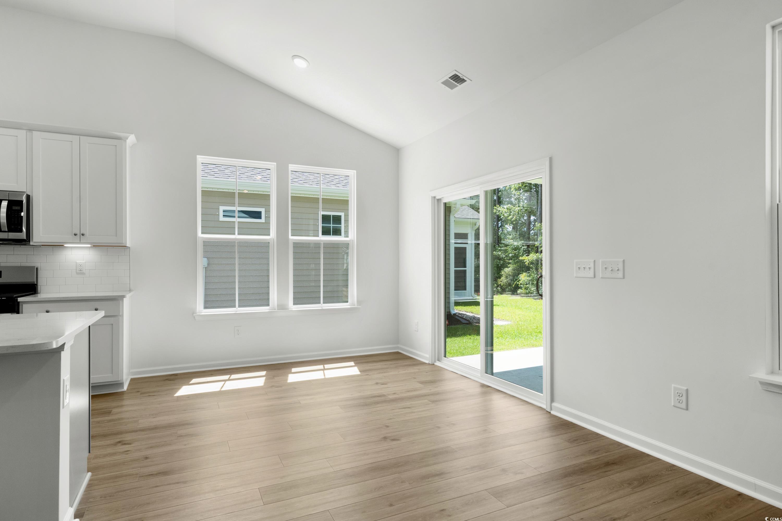 444 Sun Colony Boulevard Longs, SC 29568 - Photo 13 of 31 Dining area with 6ft windows and a sliding glass door that leads to the rear extended covered porch.