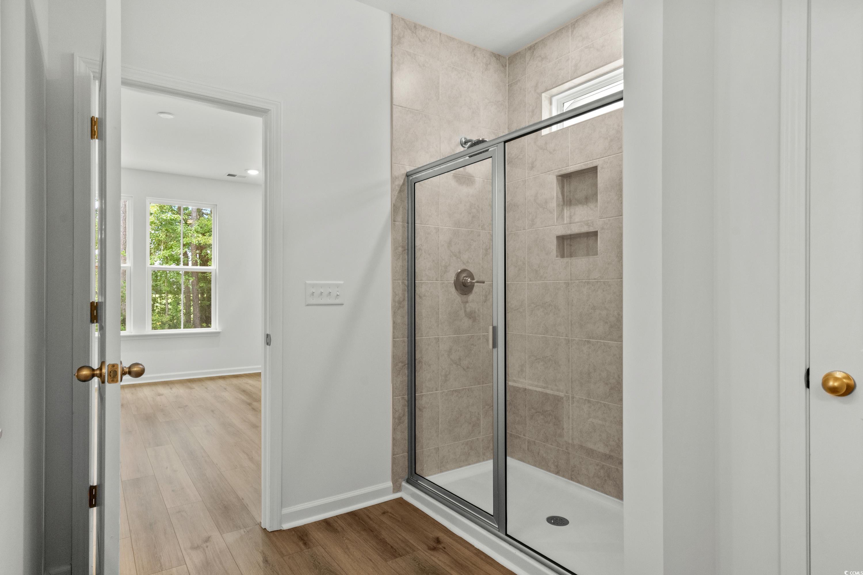 444 Sun Colony Boulevard Longs, SC 29568 - Photo 19 of 31 Primary shower with brushed satin nickel shower door, and tile to the ceiling.