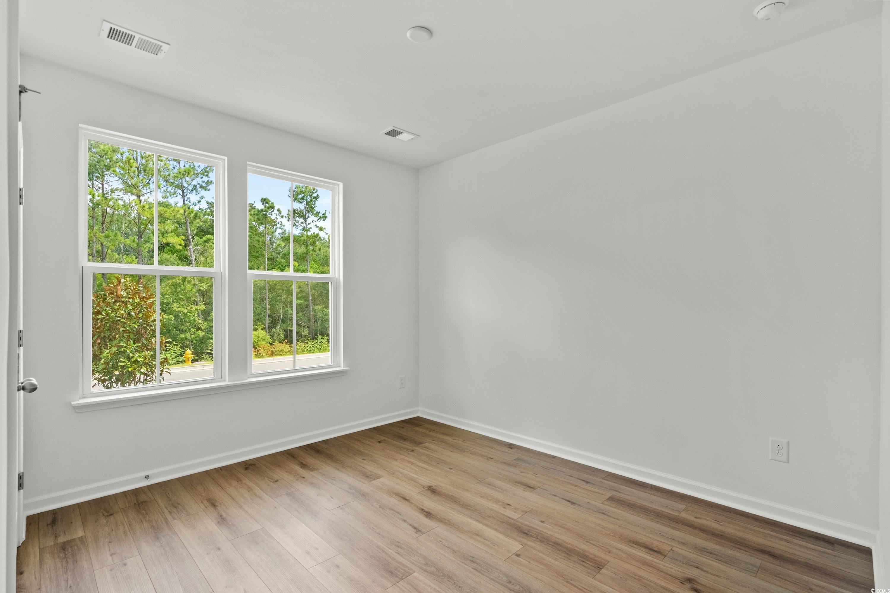 444 Sun Colony Boulevard Longs, SC 29568 - Photo 21 of 31 Guest bedroom with 6ft windows and LVP.