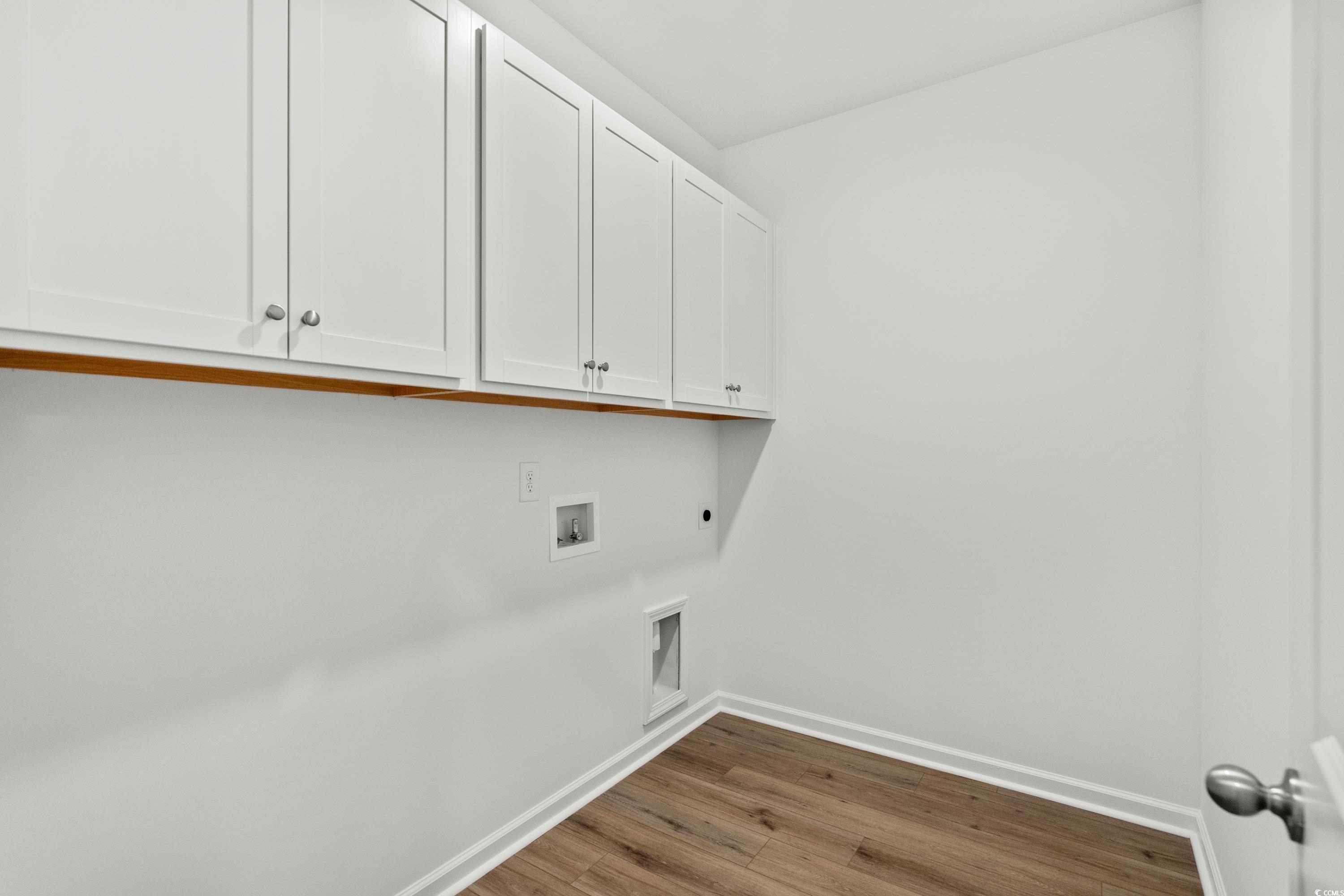 444 Sun Colony Boulevard Longs, SC 29568 - Photo 24 of 31 Laundry room with white cabinets and an electric washer and dryer hookup.