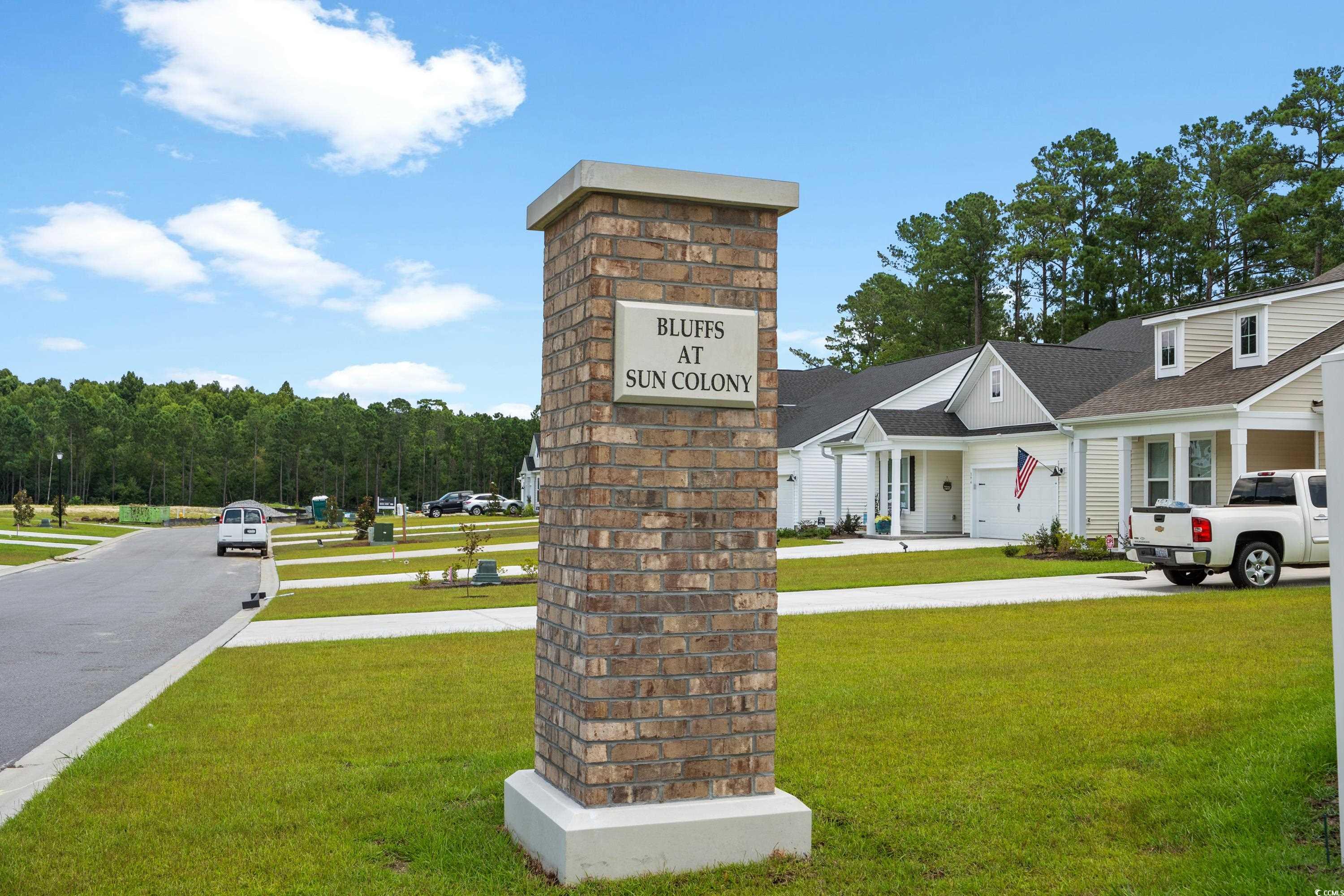 444 Sun Colony Boulevard Longs, SC 29568 - Photo 30 of 31 Community / neighborhood sign featuring a lawn