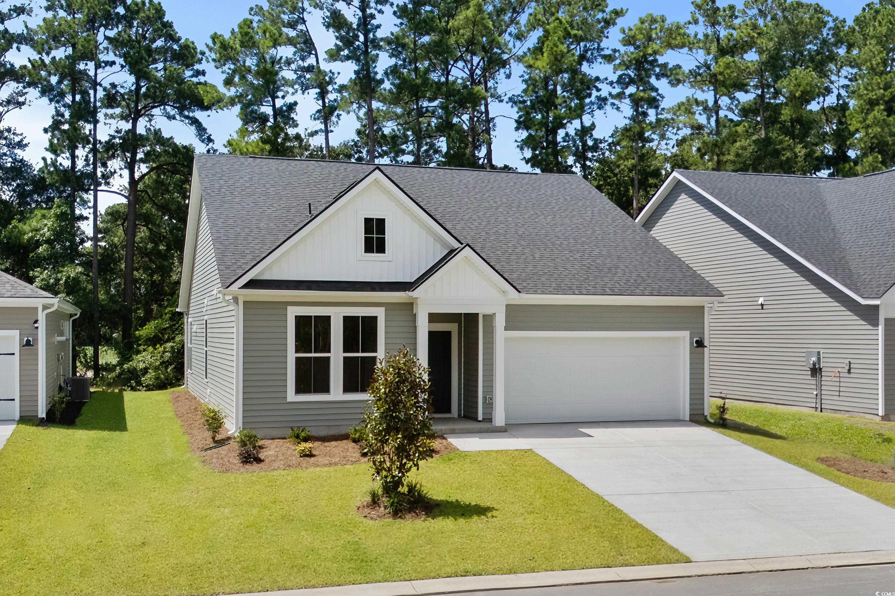 444 Sun Colony Boulevard Longs, SC 29568 - Photo 3 of 31 View of front of house with roof with shingles, an attached garage, driveway, and a front lawn