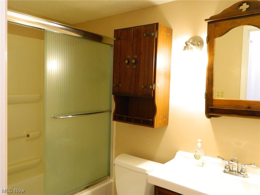 10744 Valley View Road, Unit B8 Northfield, OH 44067 - Photo 13 of 15 Bathroom has ceramic floor, shower over tub, nice vanity for storage, mirrored cabinet for storage, an additional cabinet for storage, and obviously a toilet ...