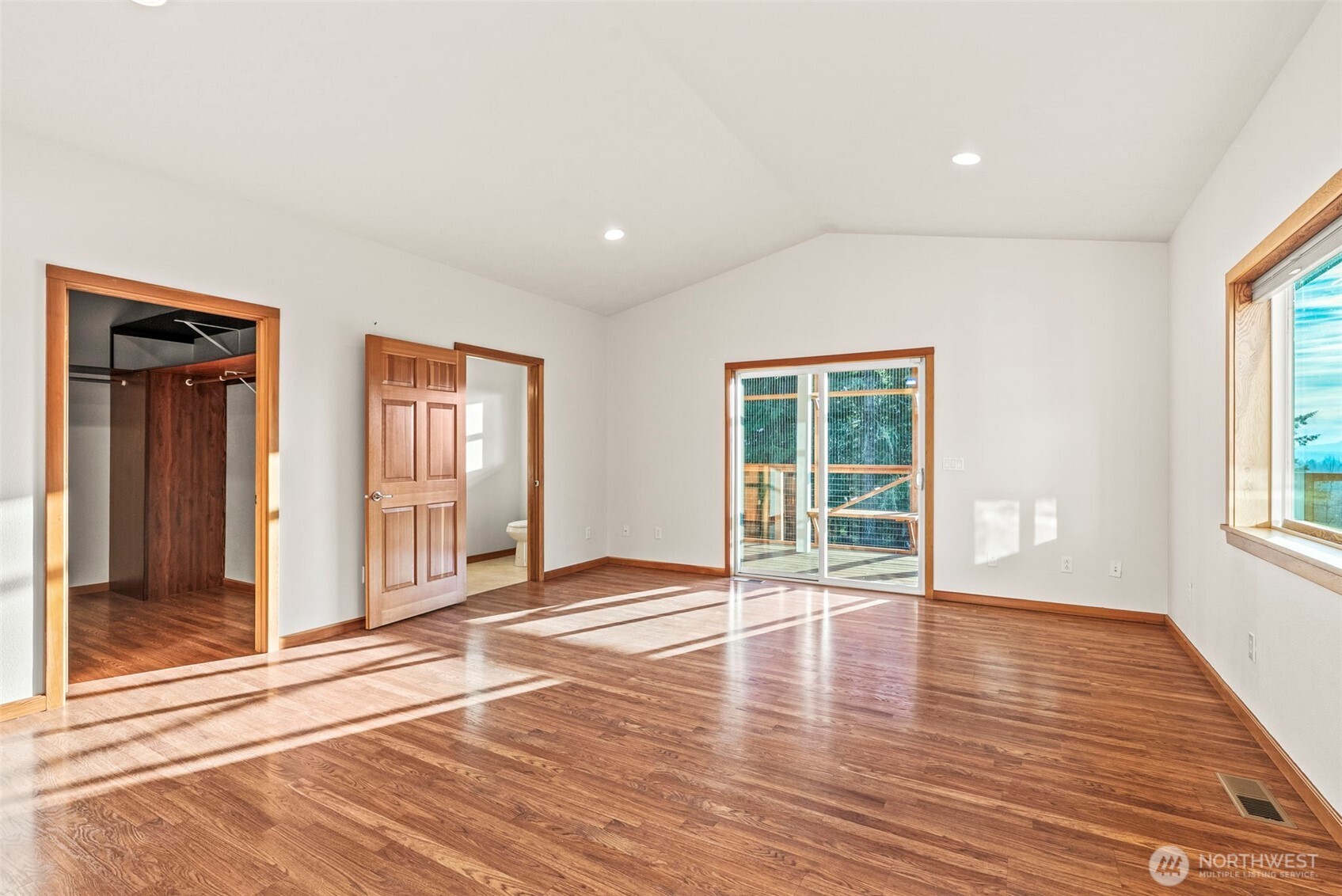 303 Shadow Mountain Road Silverlake, WA 98645 - Photo 16 of 39 a view of an empty room with wooden floor and a window