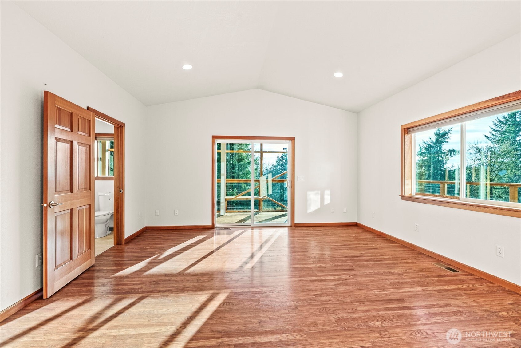 303 Shadow Mountain Road Silverlake, WA 98645 - Photo 17 of 39 a view of an empty room with wooden floor and a window