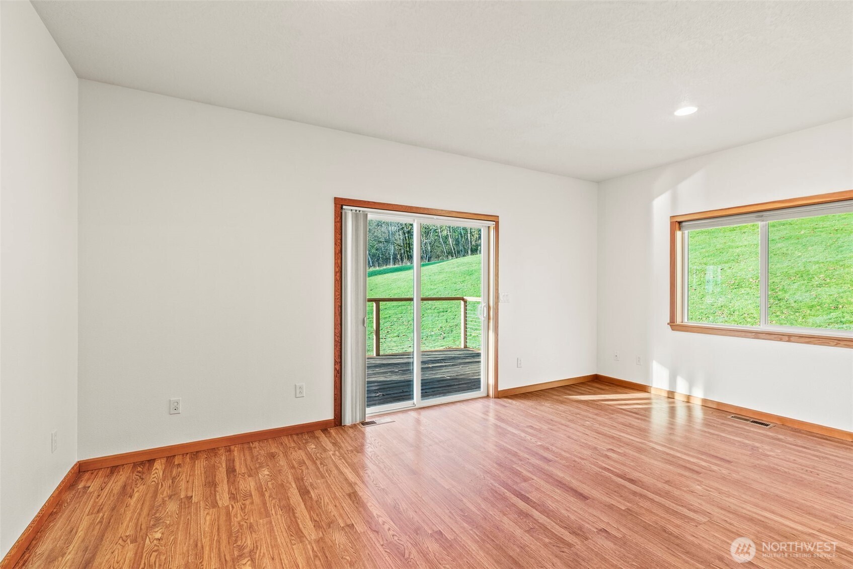 303 Shadow Mountain Road Silverlake, WA 98645 - Photo 21 of 39 a view of an empty room with wooden floor and a window