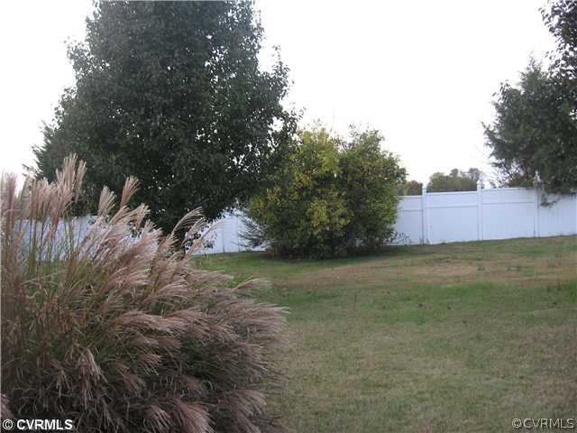 7168 Messer Road Richmond, VA 23231 - Photo 13 of 14 Yard/Garden - Expansive 2/3 acre lot surrounded by white vinyl fence offers a private, park-like setting.