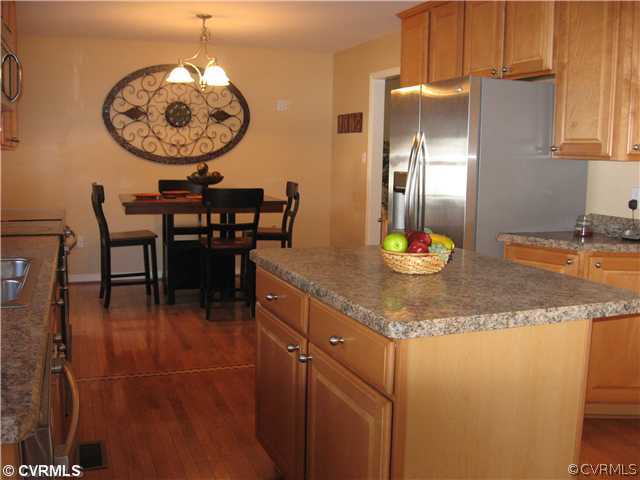 7168 Messer Road Richmond, VA 23231 - Photo 3 of 14 Kitchen - Spacious kitchen with center island offers ample counterspace. Hardwood flooring throughout kitchen and dining area. And a breakfast nook off from the kitchen as well features hardwood flooring and atrium doors that lead to the rear deck.