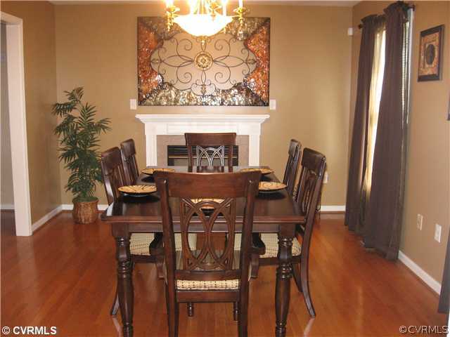 7168 Messer Road Richmond, VA 23231 - Photo 8 of 14 Living Room - Living room presently used as formal dining room features hardwood flooring and fireplace.