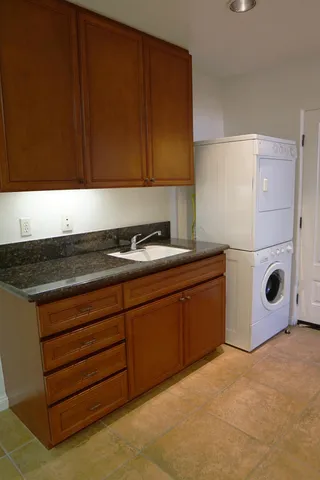 a bathroom with a granite countertop toilet sink and mirror