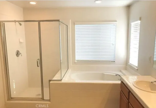 a bathroom with a bathtub and a shower