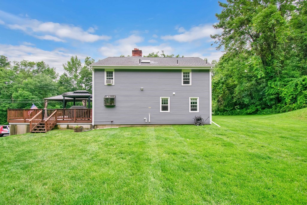 130 Warren Road Brimfield, MA 01010 - Photo 2 of 29 a view of a backyard with a garden and entertaining space