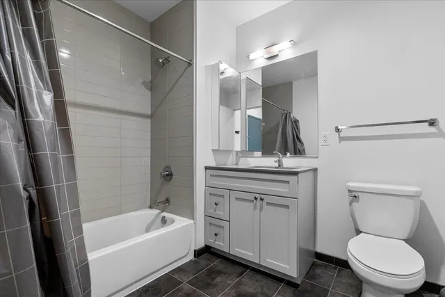 a bathroom with a sink a toilet a mirror and shower