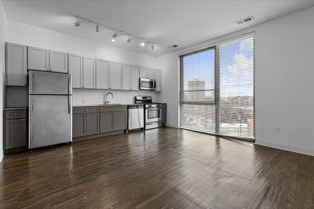 a view of a kitchen with a stove cabinets and wooden floor