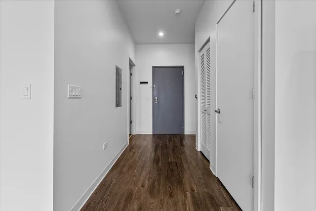 a view of a hallway with wooden floor