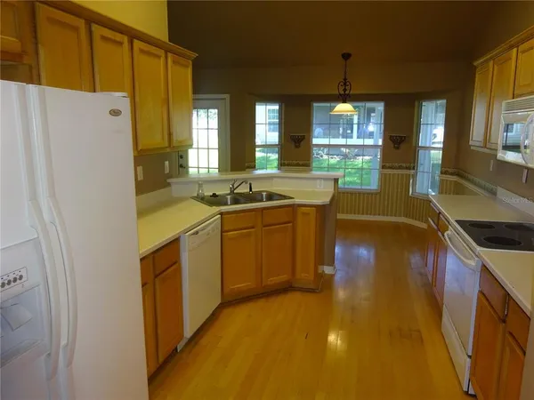 a kitchen with a sink a stove and refrigerator