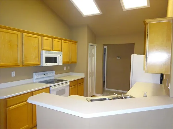 a kitchen with stainless steel appliances kitchen island granite countertop a sink and cabinets
