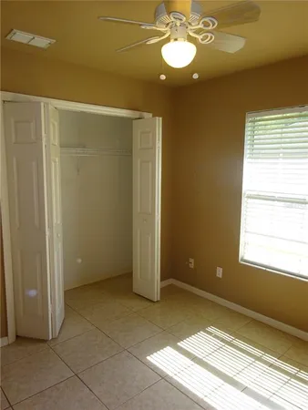 a bathroom with a granite countertop toilet a sink and a mirror