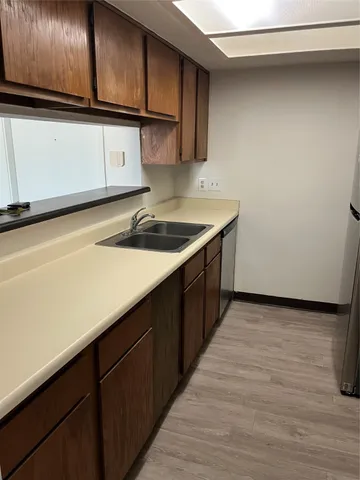 a kitchen with granite countertop a sink and cabinets