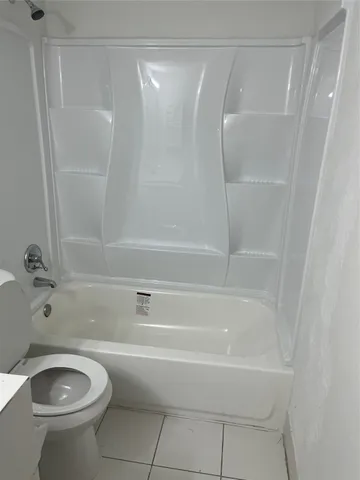 a bathroom with a shower and a toilet