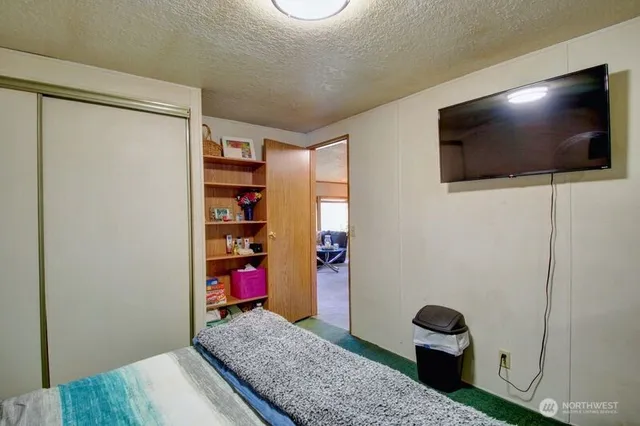 a view of a livingroom with wooden floor and staircase