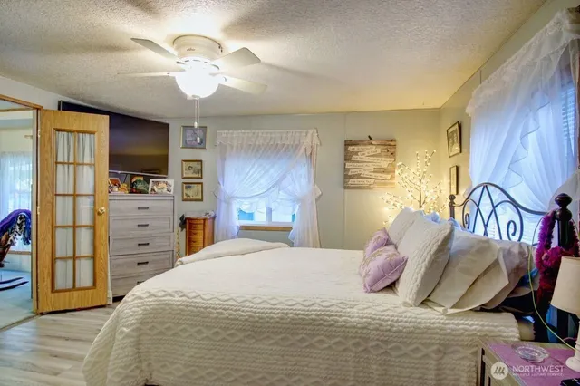 a bedroom with a bed and a chandelier