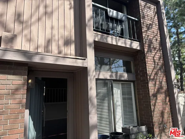 a front view of a building with a garden