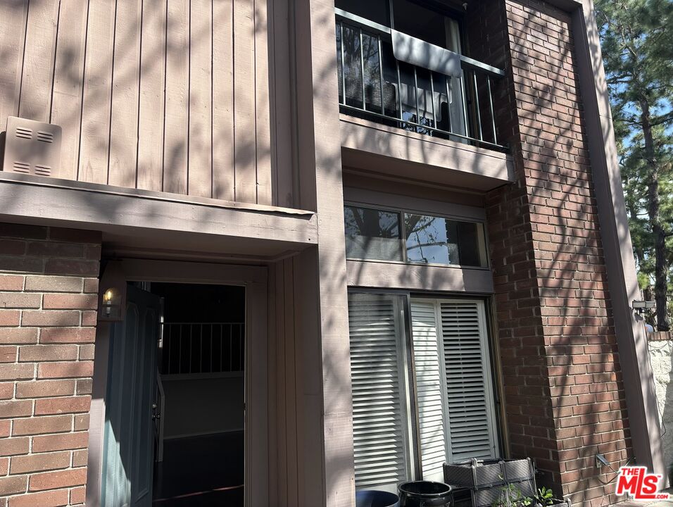 a front view of a building with a garden