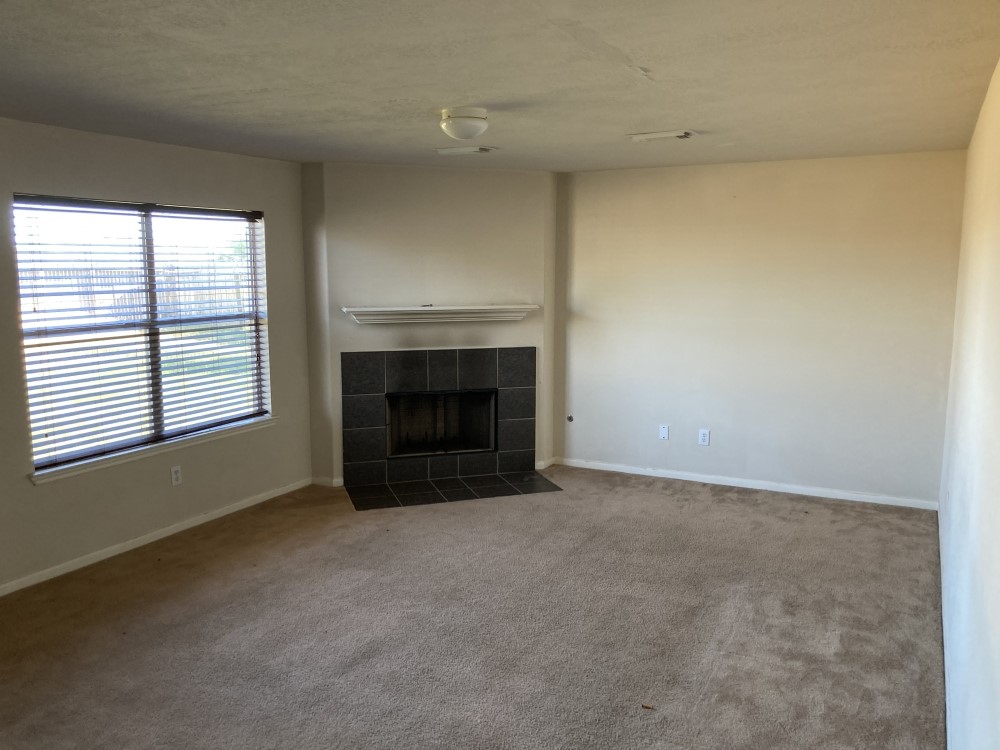 702 Silver Reef Lane La Marque, TX 77568 - Photo 4 of 9 an empty room with a fireplace