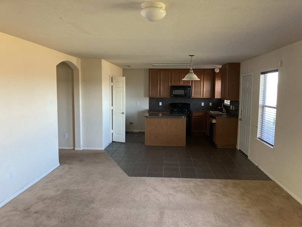 702 Silver Reef Lane La Marque, TX 77568 - Photo 5 of 9 a kitchen with a refrigerator and a stove top oven
