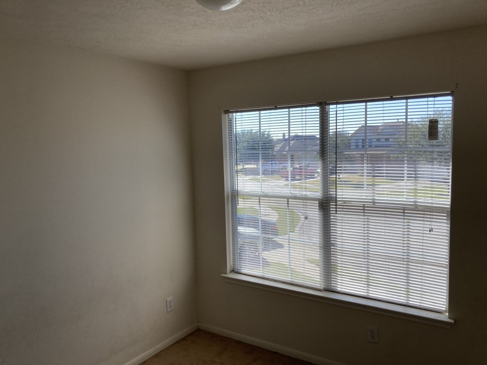 702 Silver Reef Lane La Marque, TX 77568 - Photo 9 of 9 a view of an empty room with a window