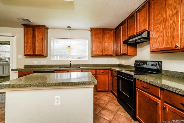 a kitchen with stainless steel appliances granite countertop a sink stove and microwave